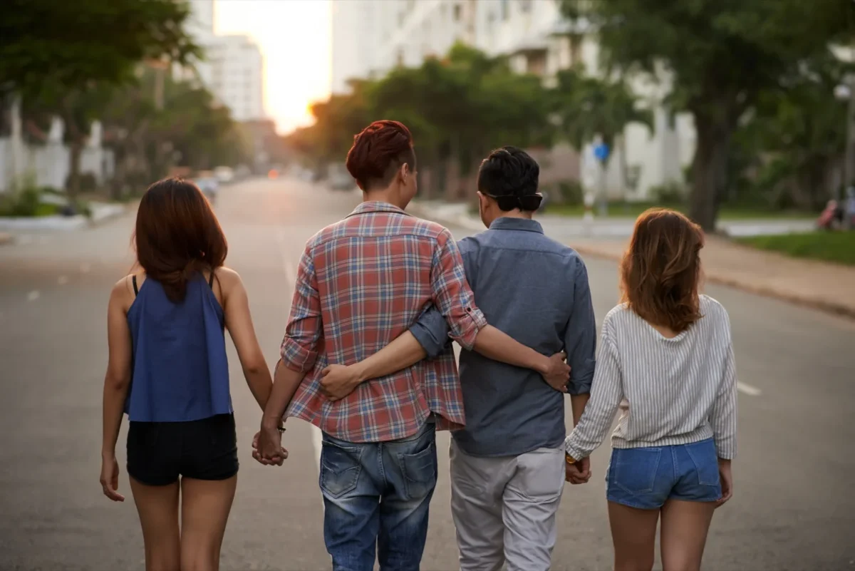 non-monogamous family walking hand in hand